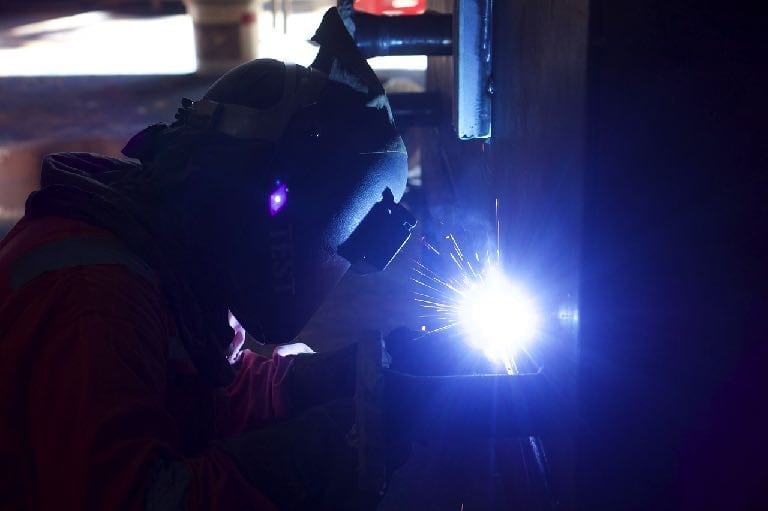 Image of welder wearing safety equipment
